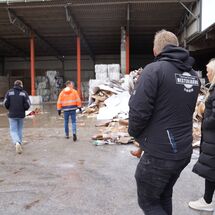 Vier Personen spazieren auf dem Hof der Anlage