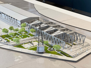 Siegerentwurf Frame Fusion Modellhalle aus vielen Streben und ohne Fassade mit Park und weiterer Halle im Hintergrund