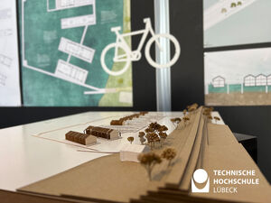 Ein architektonisches Modell mit einem Fahrrad Scherenschnitt im Hintergrund 