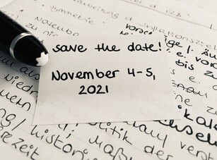 A sticky note with the handwritten date "November 4-5, 2021" on documents.