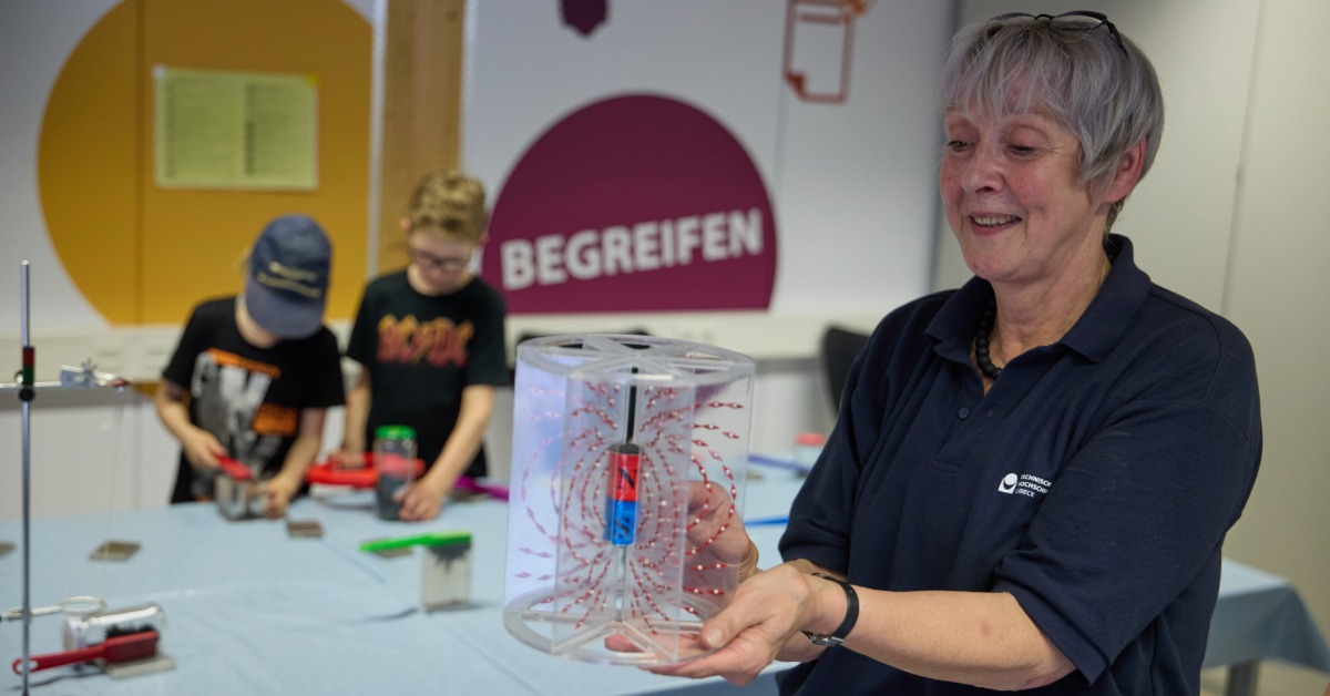 th_luebeck_juniorcampus_magnetfeldmodell Eine Mitarbeiterin vom Juniorcampus zeigt Magnetfeldmodell mit Eisenfeilspänen