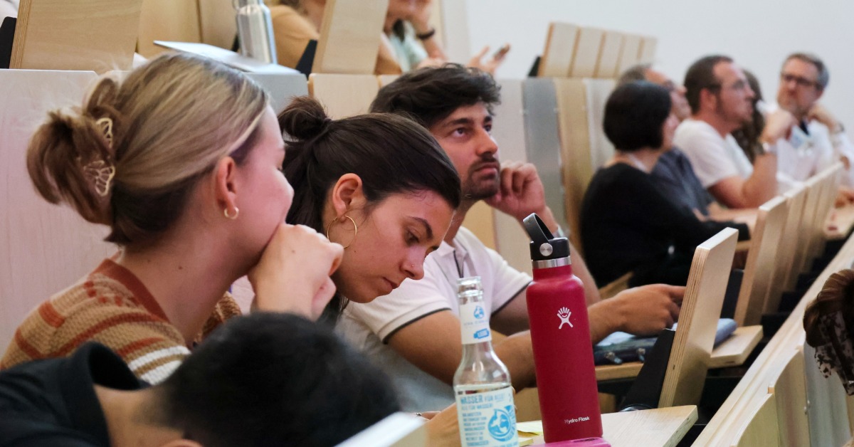Studierende verfolgen konzentriert einer Präsentation im Hörsaal